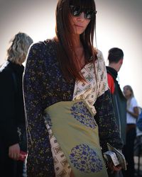 Close-up of smiling young woman wearing sunglasses