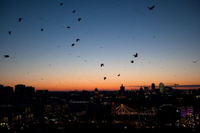 Cityscape against sky at sunset