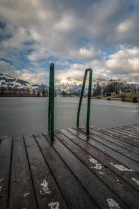 Pier over lake against sky