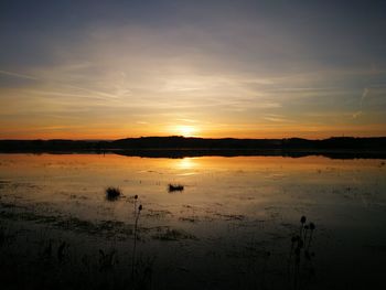 Scenic view of beach against sky during sunset