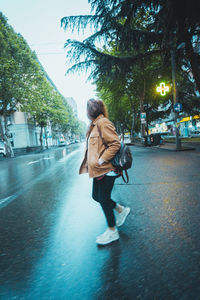 Woman walking on street in city