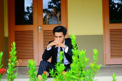 Thoughtful man sitting on porch