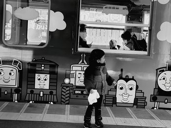 Rear view of a girl standing in bus