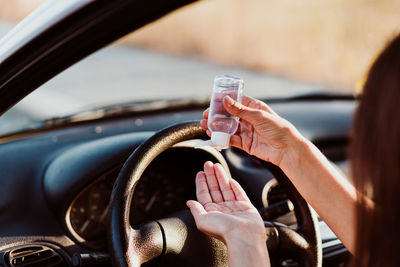 Close-up of hand holding glass of car