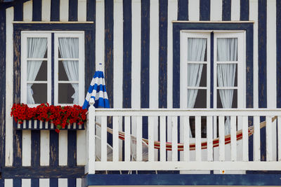 Typical colourful houses with blue and white stripes in costa nova - aveiro against sky