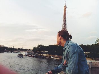 Man viewing river against eiffel tower