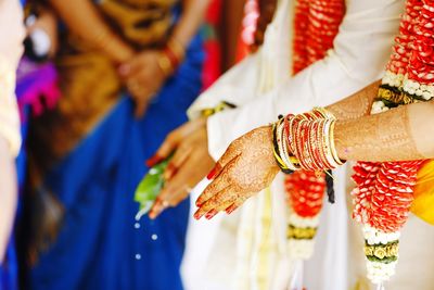 Bride and bridegroom with hands cupped during wedding ceremony