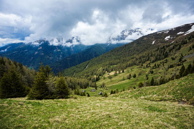 Scenic view of field and mountains against sky