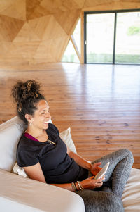 Low angle view of young woman sitting at home