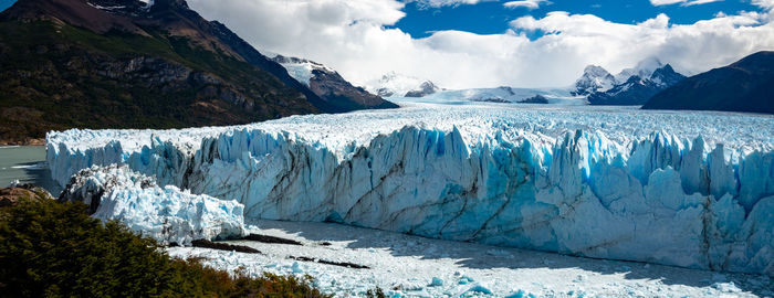 Panoramic view of frozen lake against mountain range