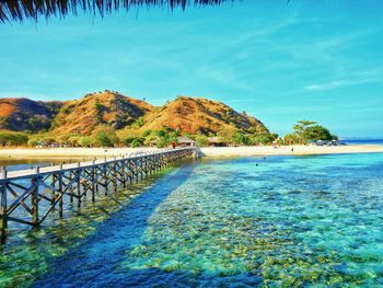 Scenic view of swimming pool by sea against sky