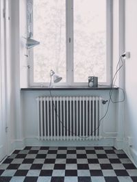 Radiator on wall below window at home