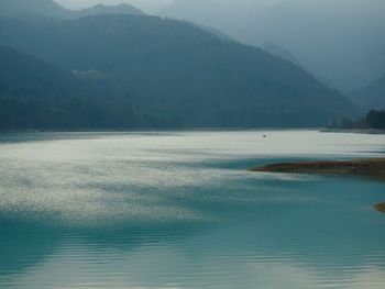 Scenic view of lake and mountains against sky