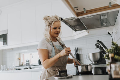 Woman cooking in kitchen