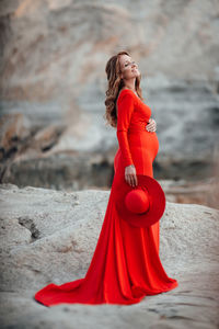 Side view of a young woman standing outdoors