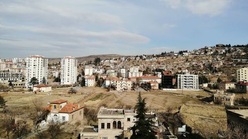 High angle view of buildings in town against sky