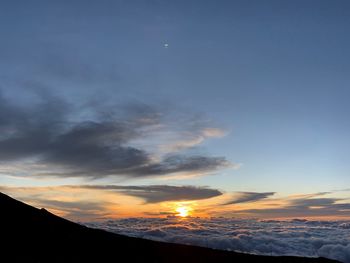 Scenic view of silhouette mountains against sky during sunset