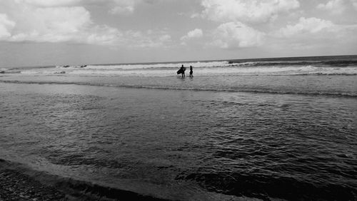 Seascape against cloudy sky