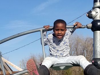 Portrait of happy boy against sky
