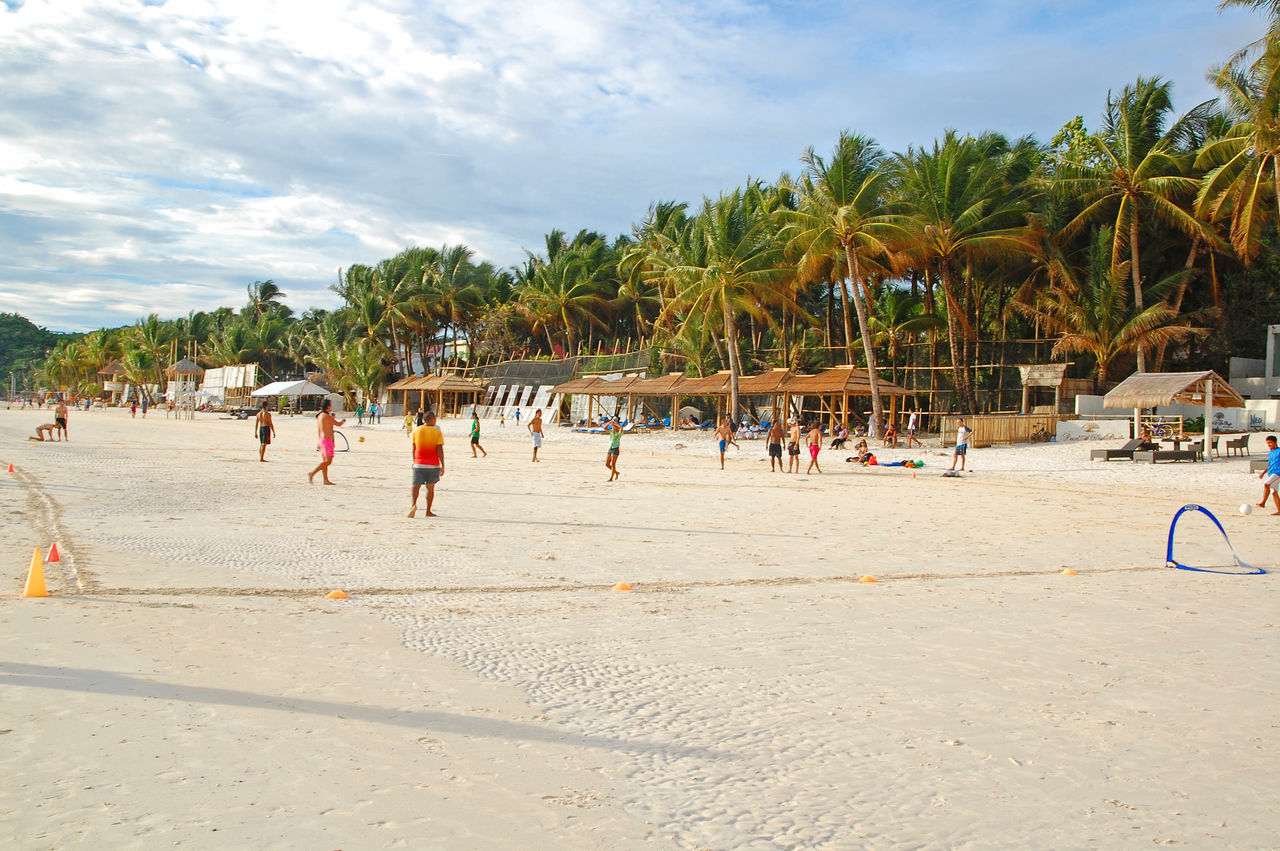 PEOPLE ON BEACH AGAINST SKY