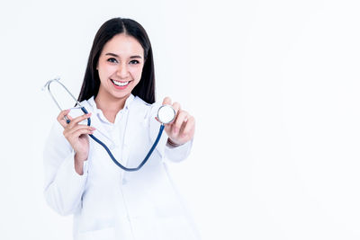 Portrait of a smiling young woman against white background