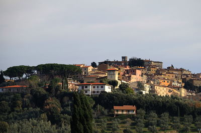 Town by hill against sky