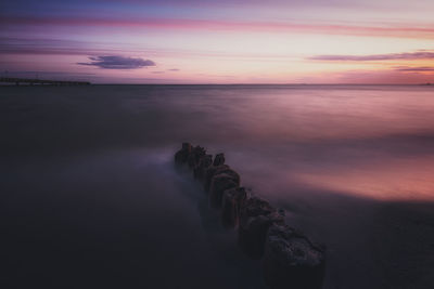 Scenic view of sea against romantic sky at sunset