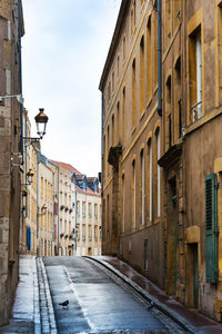 Empty road amidst buildings in town