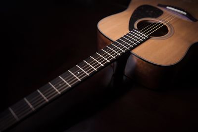 Close-up of guitar on black background