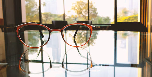 Close-up of eyeglasses on glass window