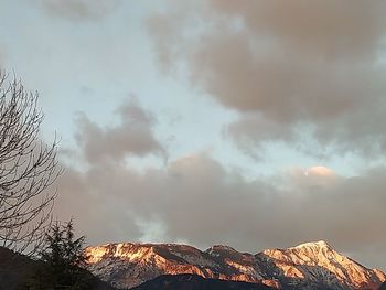 Low angle view of snowcapped mountains against sky during sunset