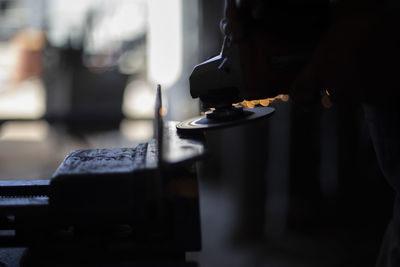 Grinding steel. worker grinds metal. work in garage. electric tool in hand. create flat surface.