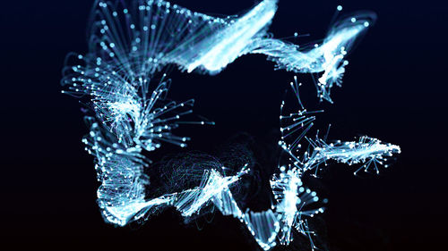 Close-up of illuminated lighting equipment against black background