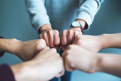 Low section of man holding hands