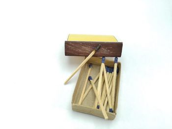 High angle view of paintbrushes on table against white background