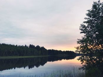 Scenic view of lake against sky at sunset