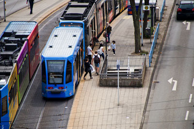 High angle view of people walking on footpath in city