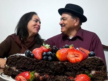 Close-up of happy young woman against gray background