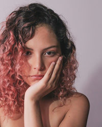 Close-up portrait of woman against white background