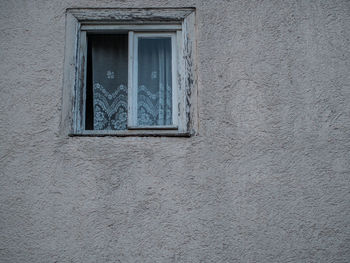 Low angle view of window on wall of building