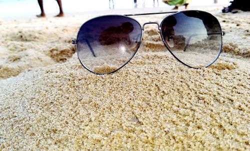 Close-up of sunglasses on beach