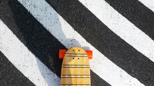Directly above shot of skateboard on crosswalk