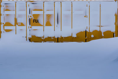 Close-up of yellow umbrella on snow