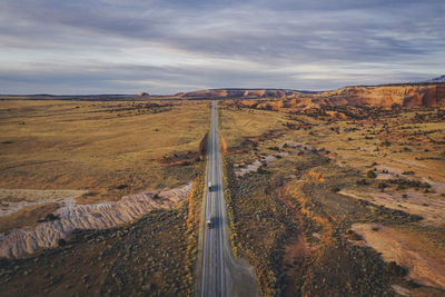 Lonely utah's road in the evening with trucks from above