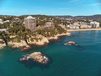 High angle view of townscape by sea against sky