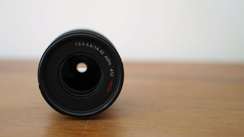 Close-up of lens on wooden table