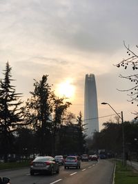 Cars on road in city against sky