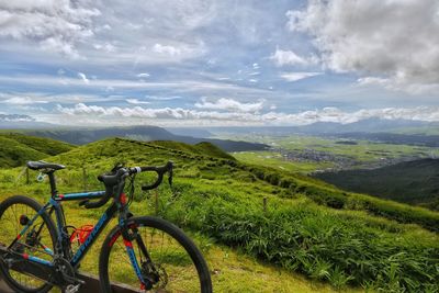 Bicycles on land against sky