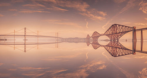 View of bridge against cloudy sky during sunset