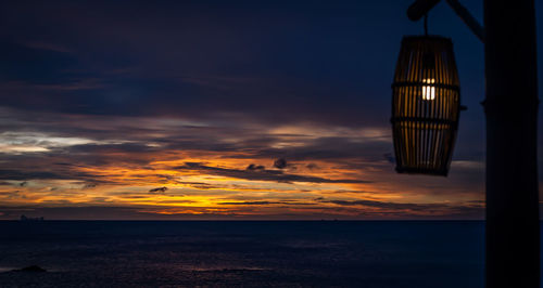 Scenic view of sea against dramatic sky during sunset